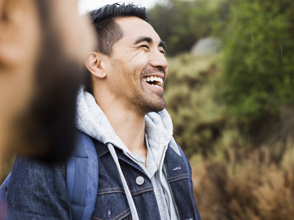 man-smiling-with-friend-after-cbt