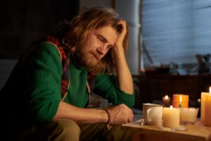 seasonal affective depression treatment, man sitting alone on a winter night